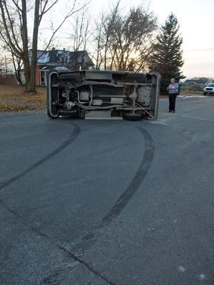 Image: Turn and flip — The collision forced the postal truck to skid sideways on two wheels until it finally flipped onto it’s side. The driver was wearing her seatbelt and was unharmed.