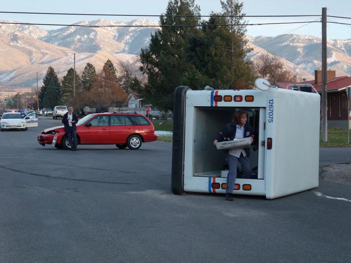 Image: The mail must go through — The postal truck driver is busy emptying her truck. Another postal truck would be there soon to pick up the mail so it can still be delivered.