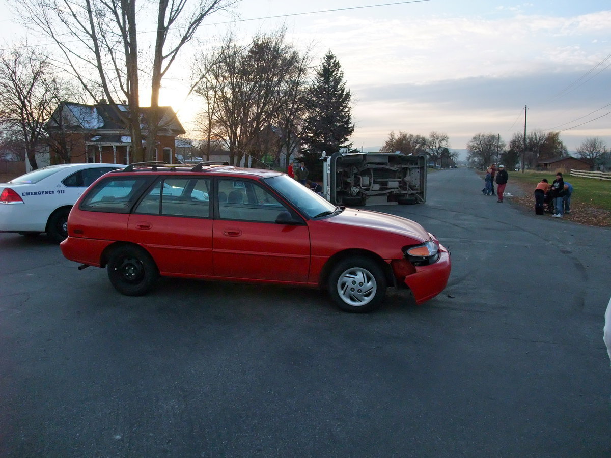 Image: Smashed bumper — The low speed collision damaged the bumper of the red sedan. The driver was unharmed.