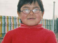 Image: Eyeglass donation — Young boy with his new glasses donated through the Lions Club.