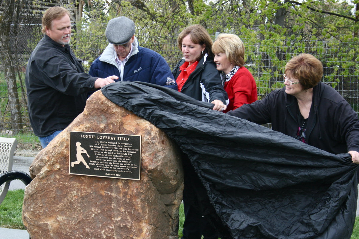 Image: Unveiling — Lonnie Loveday and four of his children unveil the Lonney Loveday Field Monument. Pictured are Jeff Loveday, Lonnie Loveday, Lonetetta Loveday Brady, Nancy Loveday Smith and Katy Loveday Stokes.