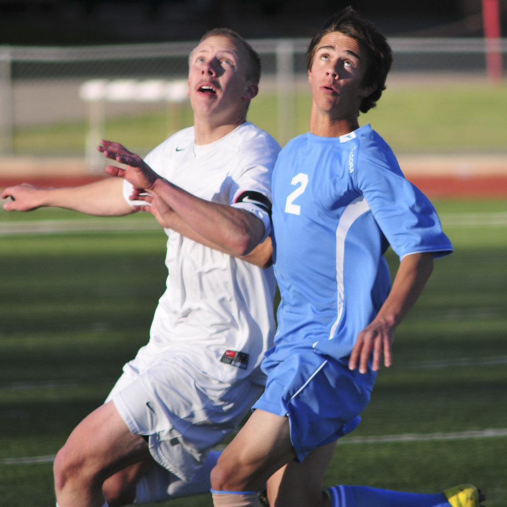 Image: Jordan Hoffman — Jordan Hoffman battles a Logan player for position under a high kick.