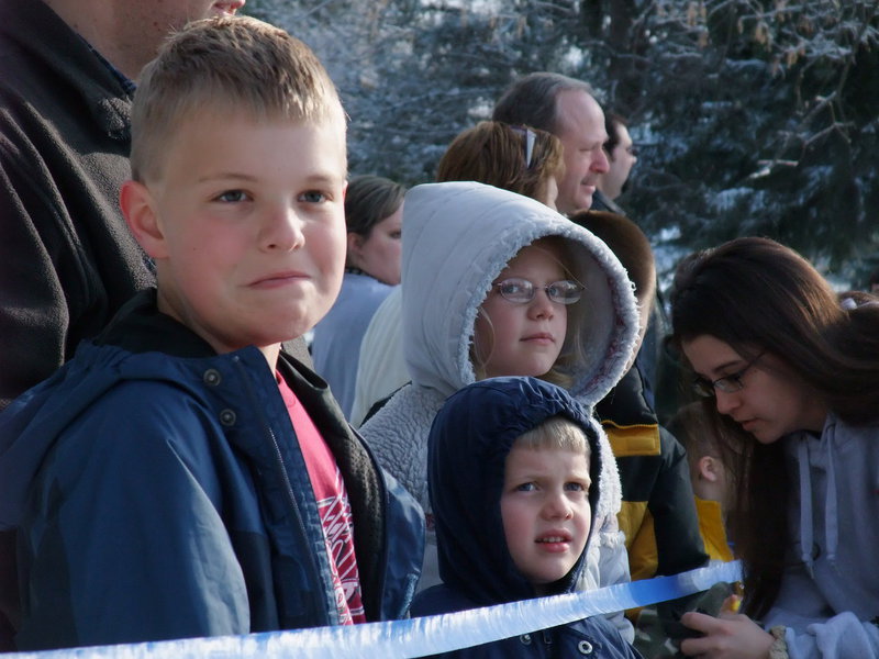 Image: Anticipation — Sam, Josh, and Eliza McMurray wait anxiously for the beginning of the Easter egg hunt.
