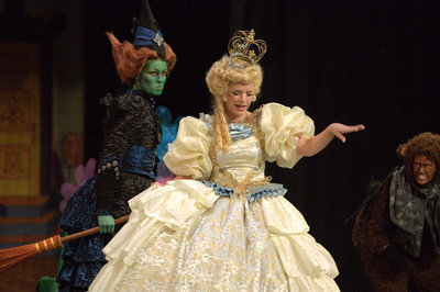 Image: Glinda the Good Witch (Marisa Allen) sends the Wicked Witch of the West (Skyler Little) packing.