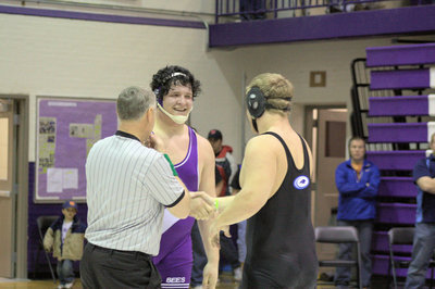 Image: Jaren Balls shaking hands with Box Elder Bee Shane Hardy after their match at the Divisional Tournament