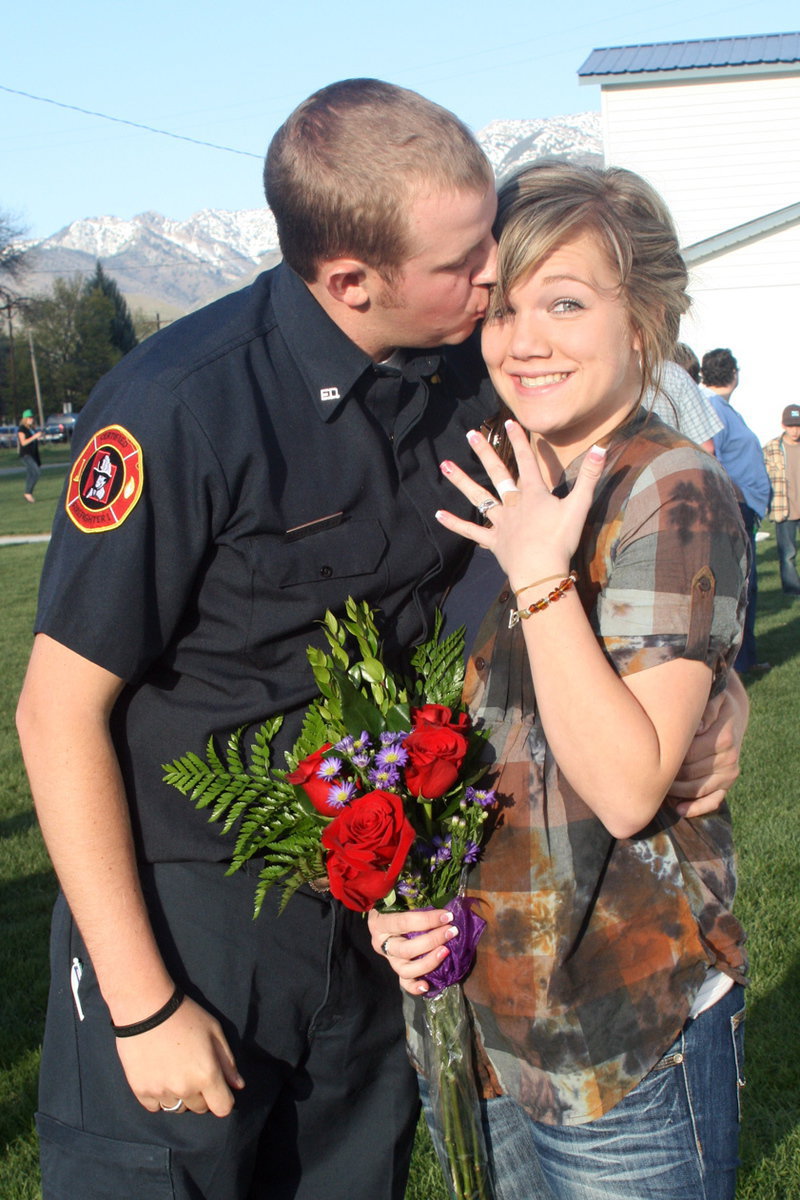 Image: She said yes — Randy Pitcher and Percell Harris with her engagement ring and a kiss.