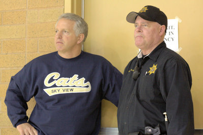 Image: Principle Dave Swenson and officer watching the final moments of the game