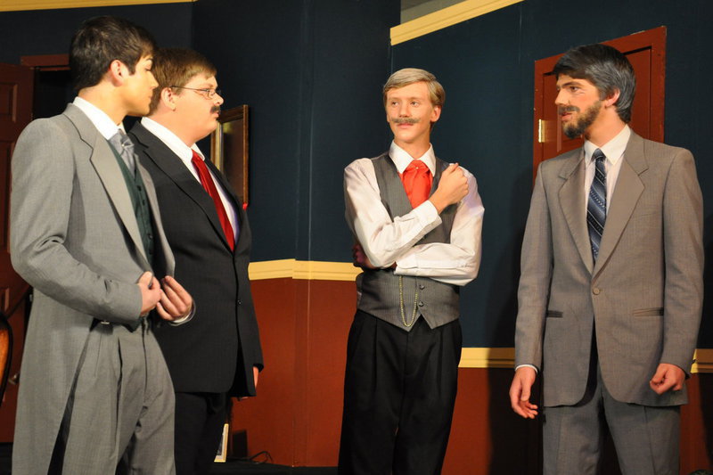 Image: Lock the doors — Mr. Standish (Will Sorensen), Mr. Mason (Tyler Jones), Mr. Crosby (Colton Iverson), and Mr. Wales (Grant Fuller) discuss how to secure the room.