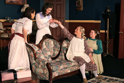 Image: Hair? — Agnes Smith (Anney Haws) showing Esther (Marissa Olson) and Rose (Cami Trappett) the lock of hair she and Tootie Smith (Alyssa Carey) pulled from John Shephard.