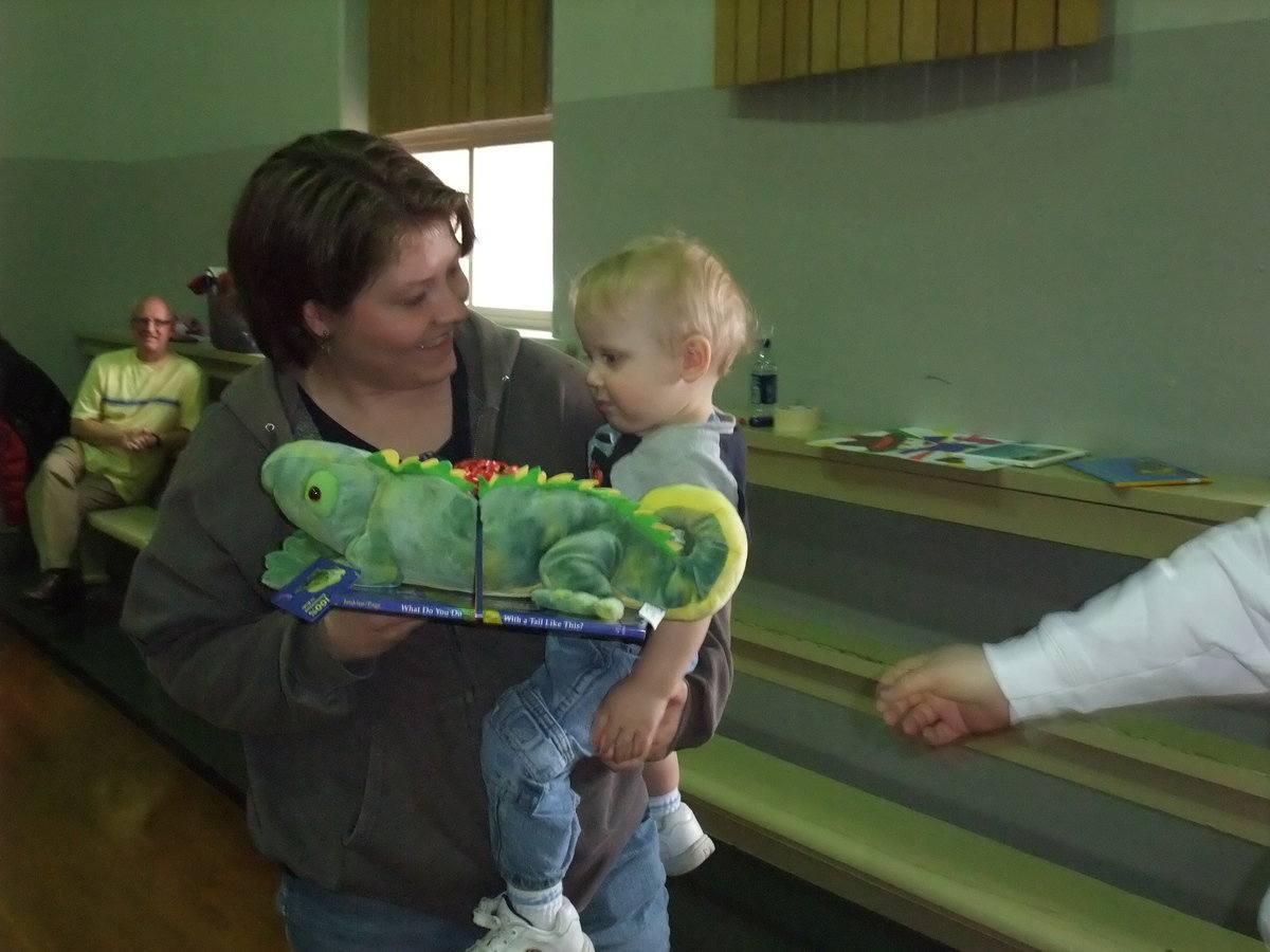 Image: Young winner — A stuffed animal and a book were given away to some of the children.