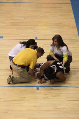 Image: Injured player — Marcus Maw attends to injured highland player