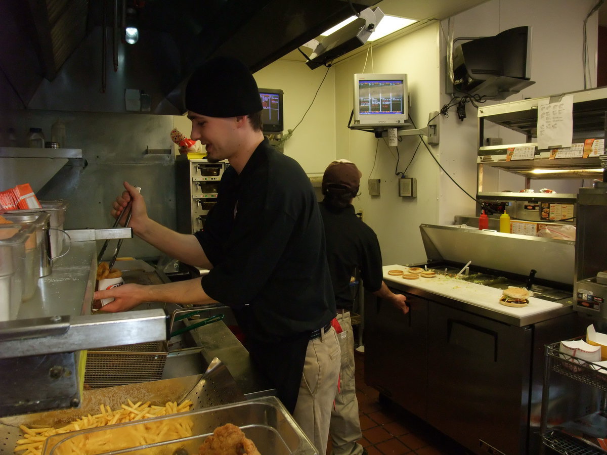 Image: Alex Davies — Alex Davies, owner of the Smithfield A&amp;W, filling an order of onion rings as he and his employees work hard to clear the queue on the screen. “From 11:30 to 9 p.m. we never saw the end of the screen,” said Davies.