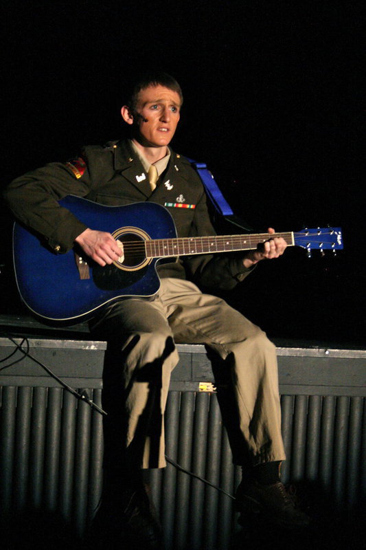 Image: Christmas at war — Taylor Smith singing Belleau Wood by Garth Brooks, a song about the Allies and the Germans singing silent night on the front lines of WWI during a Christmas Truce.
