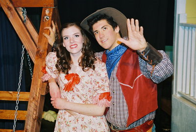 Image: Go to the dance with me — Curly McLain (Josh Hilton) trying to persuade Laurey Williams (Marissa Olsen) to come with him to the box social dance.