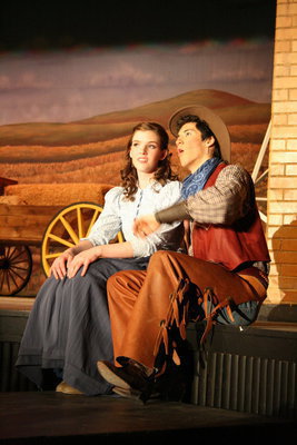 Image: Fringe on the top — Curly McLain (Josh Hilton) singing The Surrey With The Fringe On Top to Laurey Williams (Marissa Olsen) about the wonderful carriage he plans to take her to the dance in.