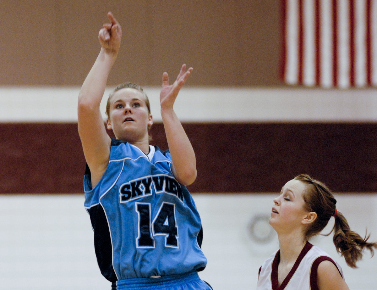 Image: Nicole Hansen — Senior guard/forward Nicole Hansen shoots over a Logan Grizzly.