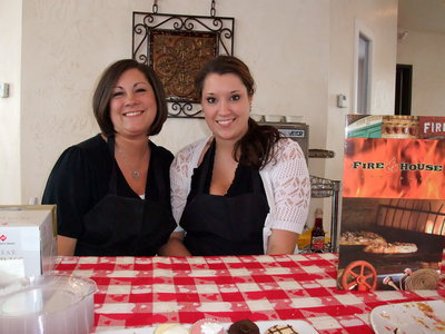 Image: Firehouse Pizzeria — Representatives from Firehouse Pizzeria demonstrating their catering menu of food.
