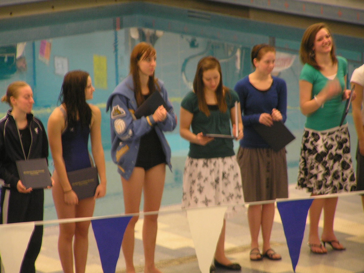 Image: Academic All-State — Sky View athletes Laura Mortenson (Sky View jacket) and Ashley Lee (dark green shirt) receiving their certificate for academic all-state.