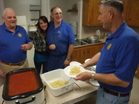 Image: Dishing up dinner and smiles — Smithfield Lions Club members Keith Hansen, Tom Arquette and Kenneth Hansen preparing and serving spaghetti dinner.