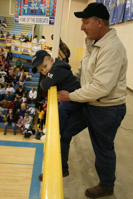 Image: Jackson — Clayd Gardner lifts his two-year-old son, Jackson, so he can see the game.