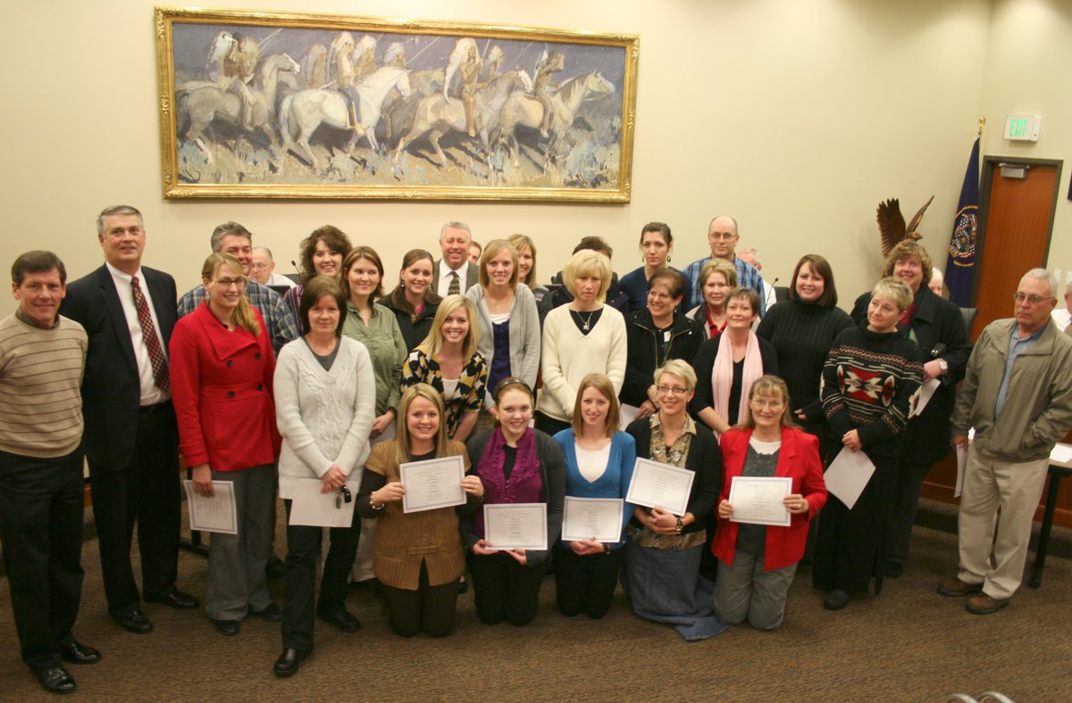 Image: Nucor Steel Grants — Charlie Zurcher and Steve Roland (both on far left) presented grants on behalf of Nucor Steel to dozens of educators in the Cache County School District.