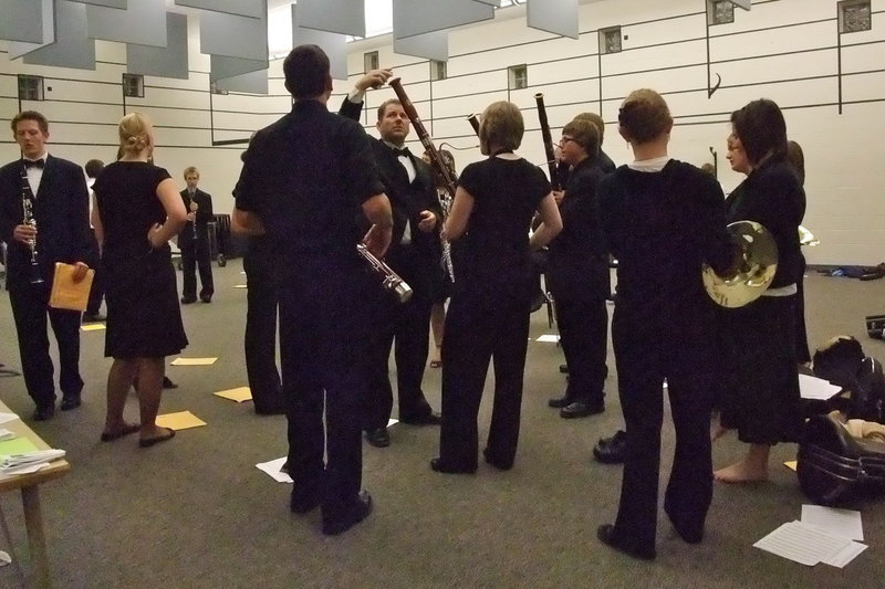 Image: Tuning — Randall Beach, Sky View Band Director, holds an electronic tuner near the end of a bassoon. Each student had to pass the “tune” test before heading to the auditorium.