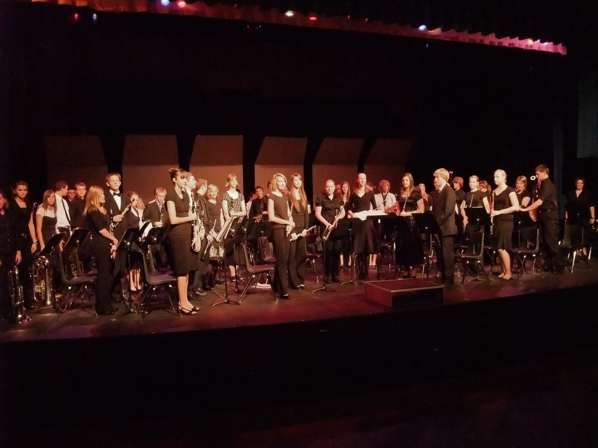 Image: Taking their bow — All musicians stand to accept the applause of the audience.