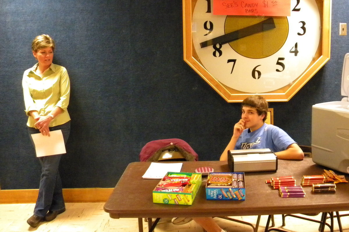 Image: Concessions — Sherri Petersen observes while Andrew Dunford supervises the concessions table