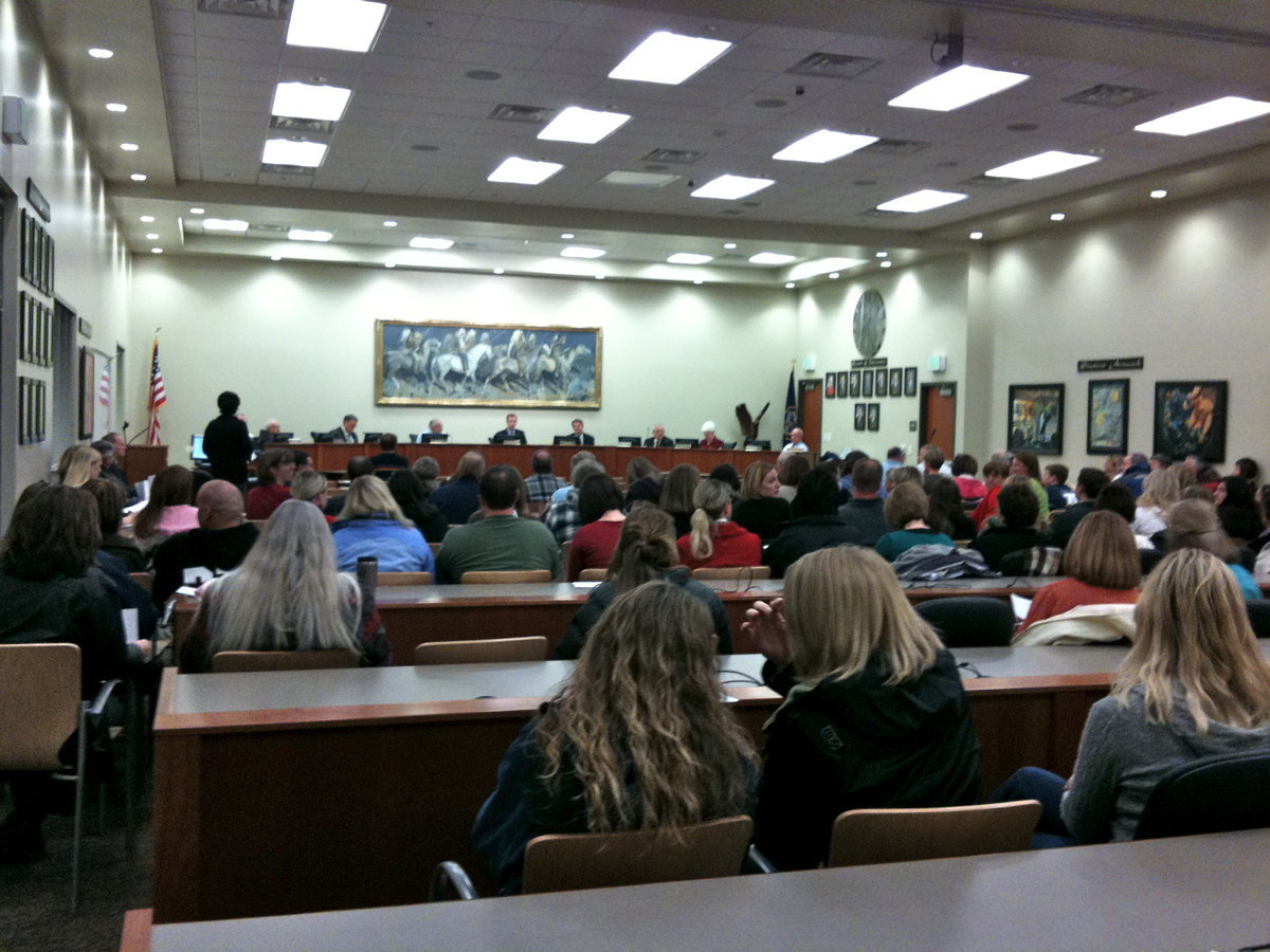 Image: Large audience — A packed board room of spectators and speakers expressing their opinions on changing North Cache elementary schools to K-5.