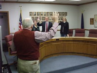 Image: Clegg giving the oath — City Recorder Dean Clegg giving the oath of office to Barbara Kent, Darrell Simmons and Kris Monson.