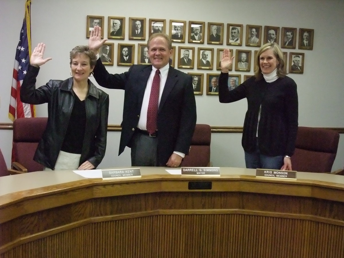 Image: New officials — Just sworn in as a new city councilwoman, Barbara Kent; new mayor, Darrell Simmons; and returning city councilwoman, Kris Monson.