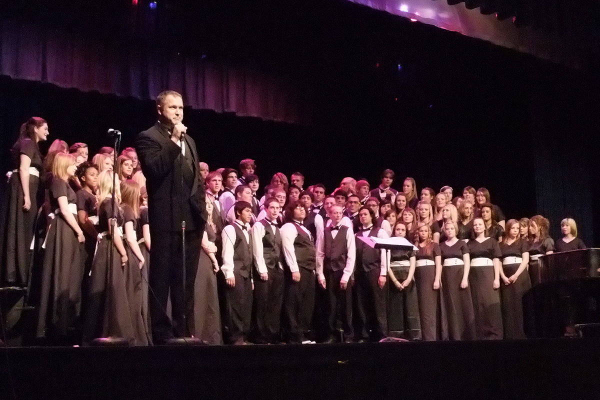 Image: Performance begins — Caldwell announcing the first number of the choir concert.