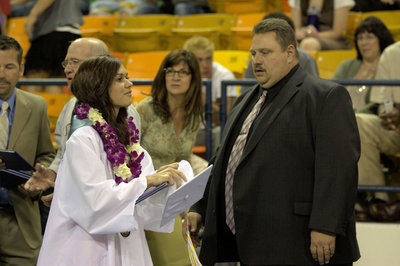 Image: Kiana Hola receives her diploma and a beautiful lei