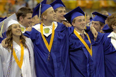 Image: Sky View Graduates sing the school song at the conclusion of the graduation ceremony