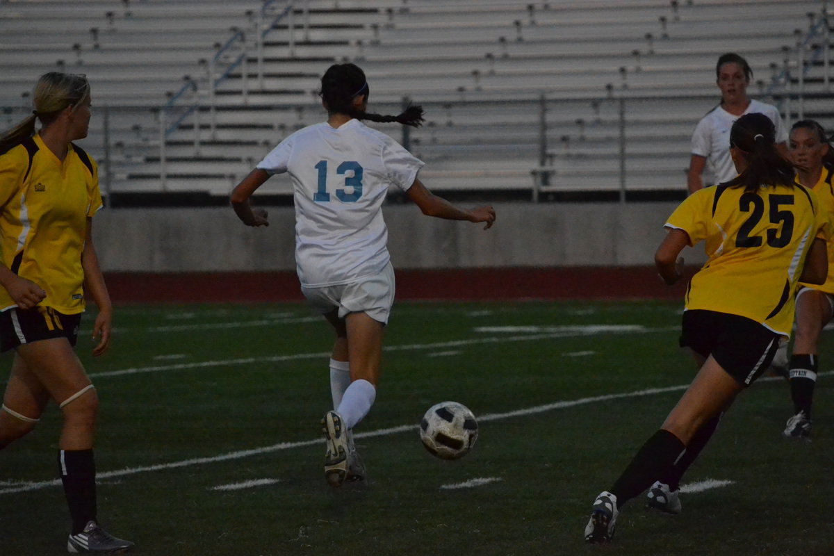 Image: Brenna Porter dribbles between Roy defenders.