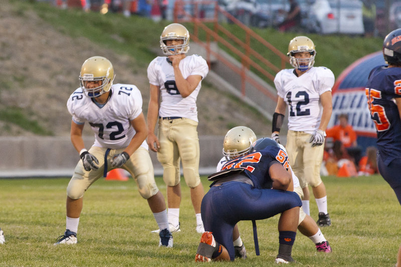 Image: Nick Carver (8) and Alex Watts (12) look over the defense, while Josh Watteyne (72) gets ready to block.