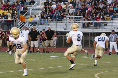 Image: Nick Carver # 8 dropping back to pass, while Alex Watts # 12 and Sean Gero # 20 head go in motion to the outsides.