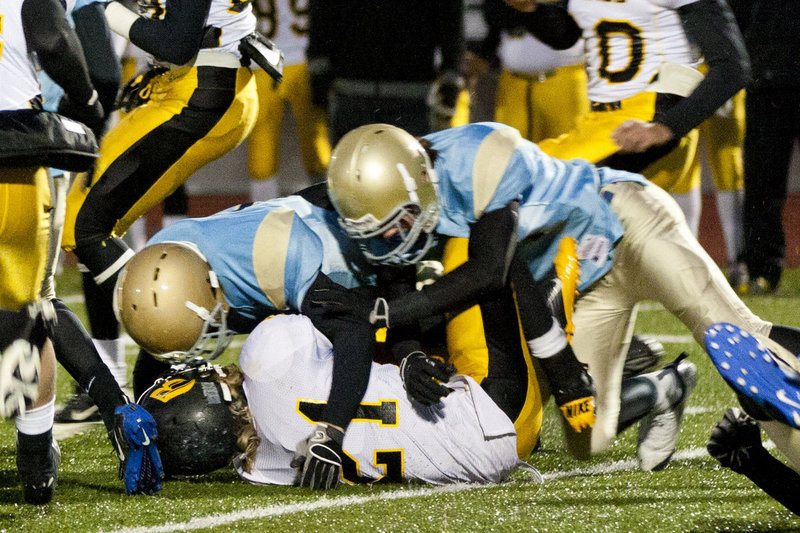 Image: The Bobcats smother the Royals running back.  A huge defensive night for the Bobcats forced six turnovers.
