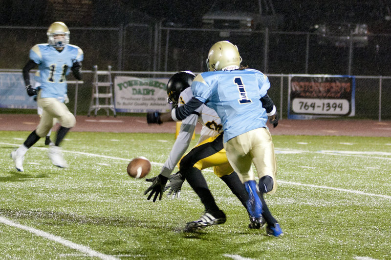 Image: Yabitse Wells (#1) defends a pass, as Tyler Stevens (#11) in the background closes in.