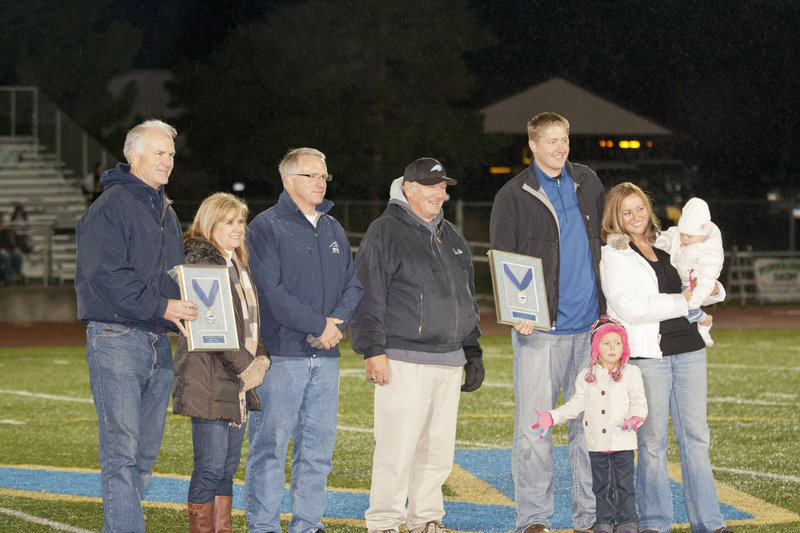 Image: At halftime Justin Wilcox’s parents on the left accept his award for being inducted into the Sky View Hall of Fame.  Principal Swenson &amp; Jan Hall in the middle.  Nate Harris and his family accept his Hall of Fame induction award.