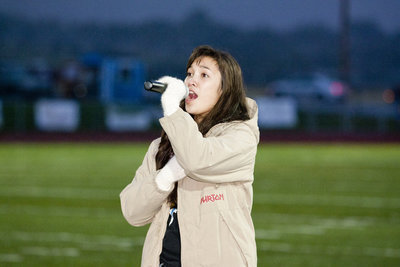 Image: Abrianne Storey sings the national anthem before the game.