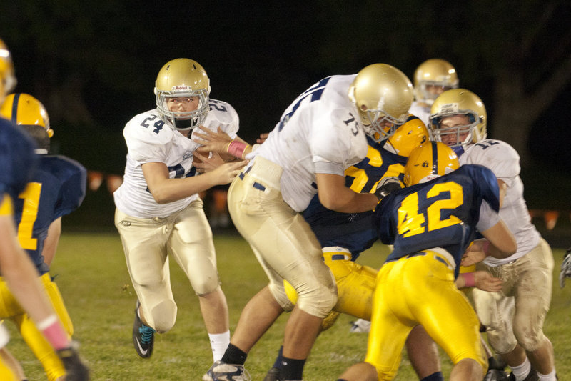 Image: Skyler Hunt (#24) looks to squeeze through the hole created by big Sheay Johnson (#75)