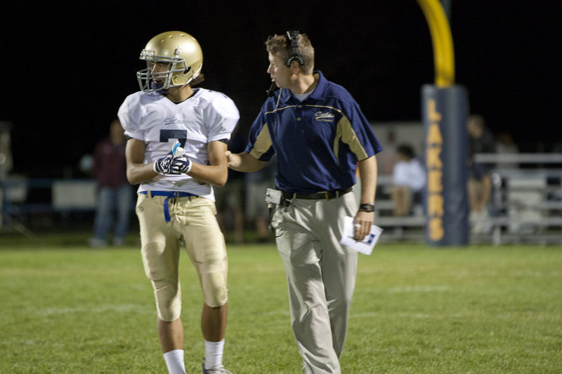 Image: Head Coach Craig Andher gives instructions to Brandon Burger (#7)