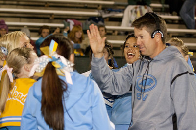 Image: Coach Anhder high-fives the cheerleaders at the beginning of the second half.