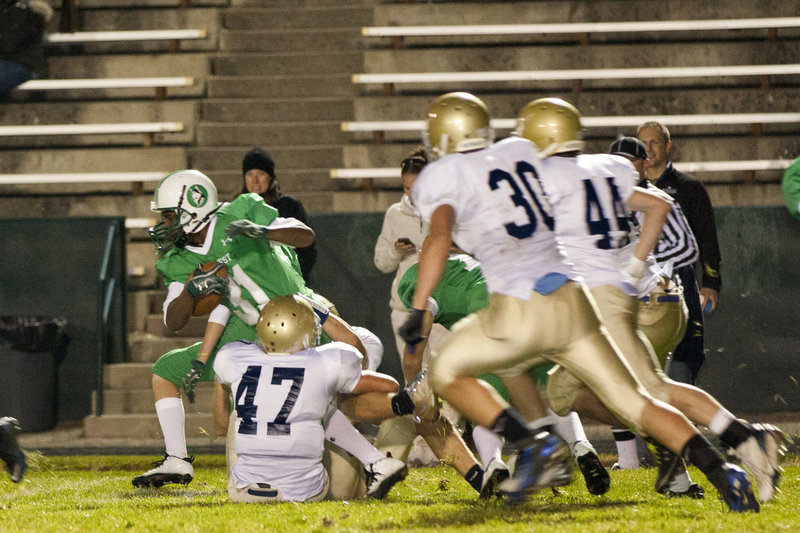 Image: Kyle Standing (#47) slows up the runner while Robert Ercanbrack (#30) and Kyle Jorgensen (#44) are in hot pursuit