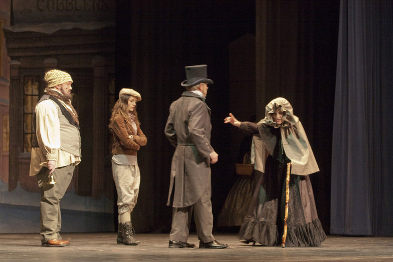 Image: Scrooge rebuffs the towns people including a blind woman in the square.