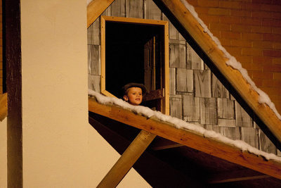 Image: Tiny Tim sings of his excitement for Christmas from his attic window.
