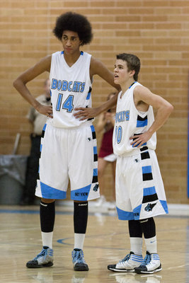 Image: The tall and the short of it.  Varsity starters, Jalen Moore (14) and Riley Knowles (10) discuss the game during a free throw