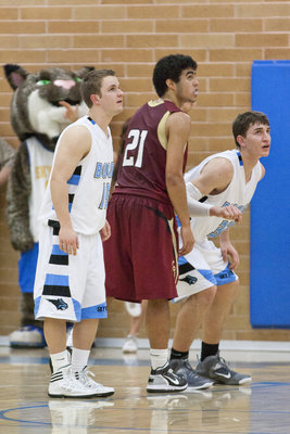 Image: Jason Oliverson (15), and Casey Oliverson (32) prepare to rebound on a pair of Logan free throws.
