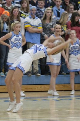Image: Cheerleaders flip and fly during a late game time out.